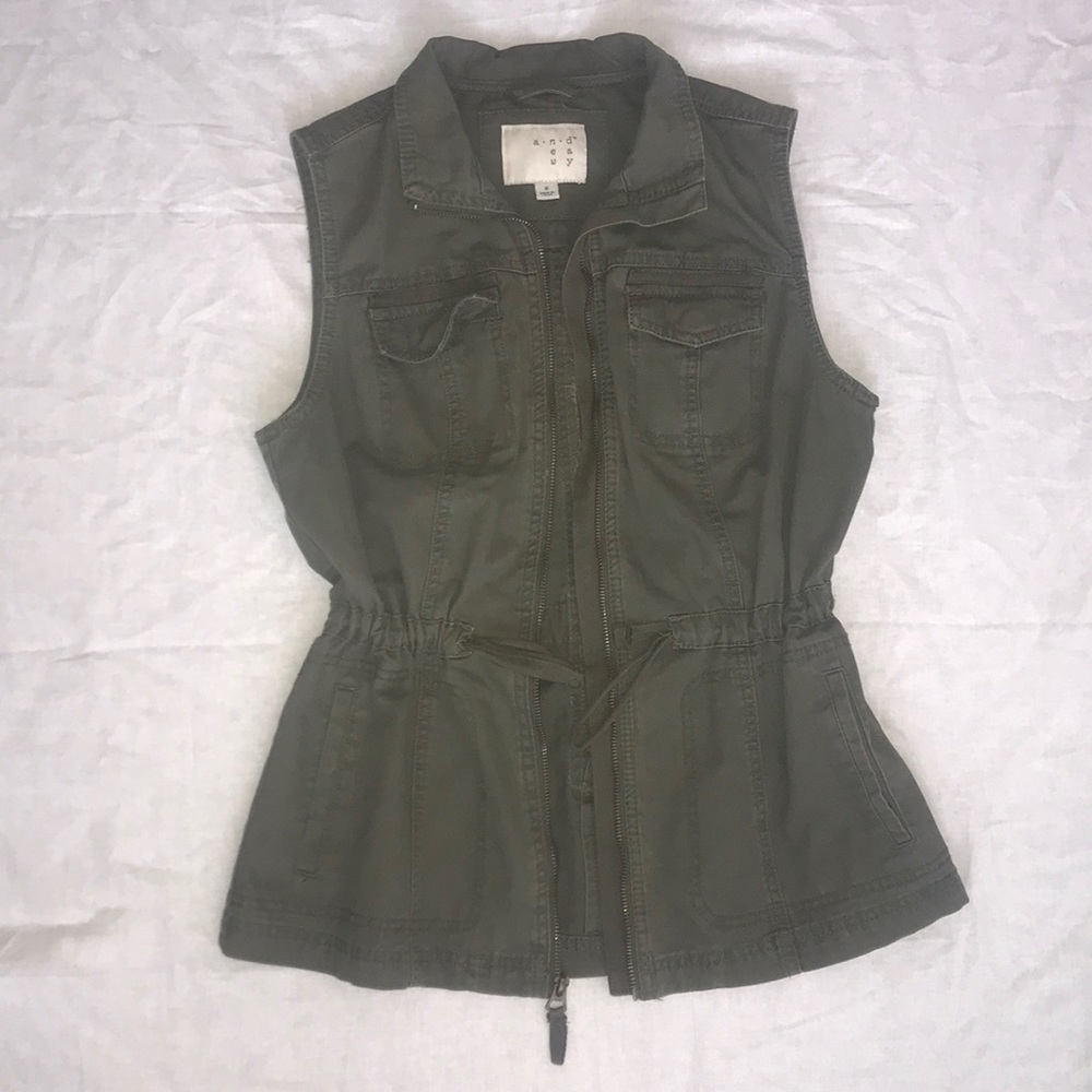 Army green vest with waist cinch.